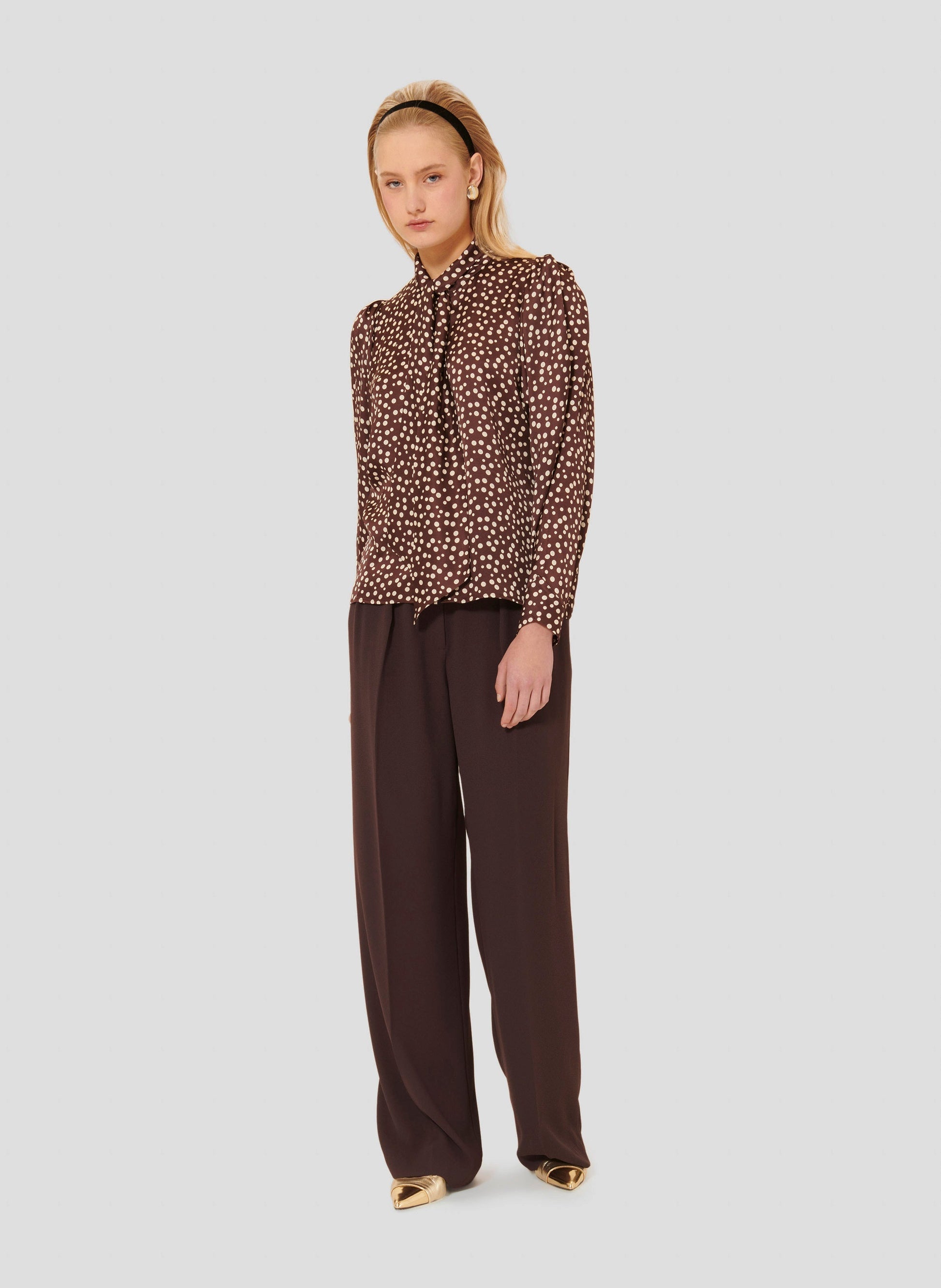 Puffed long sleeves brown shirt with white polka dots. 