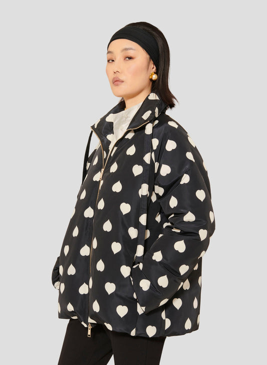 Tara Jarmon model wearing black down jacket with white hearts.