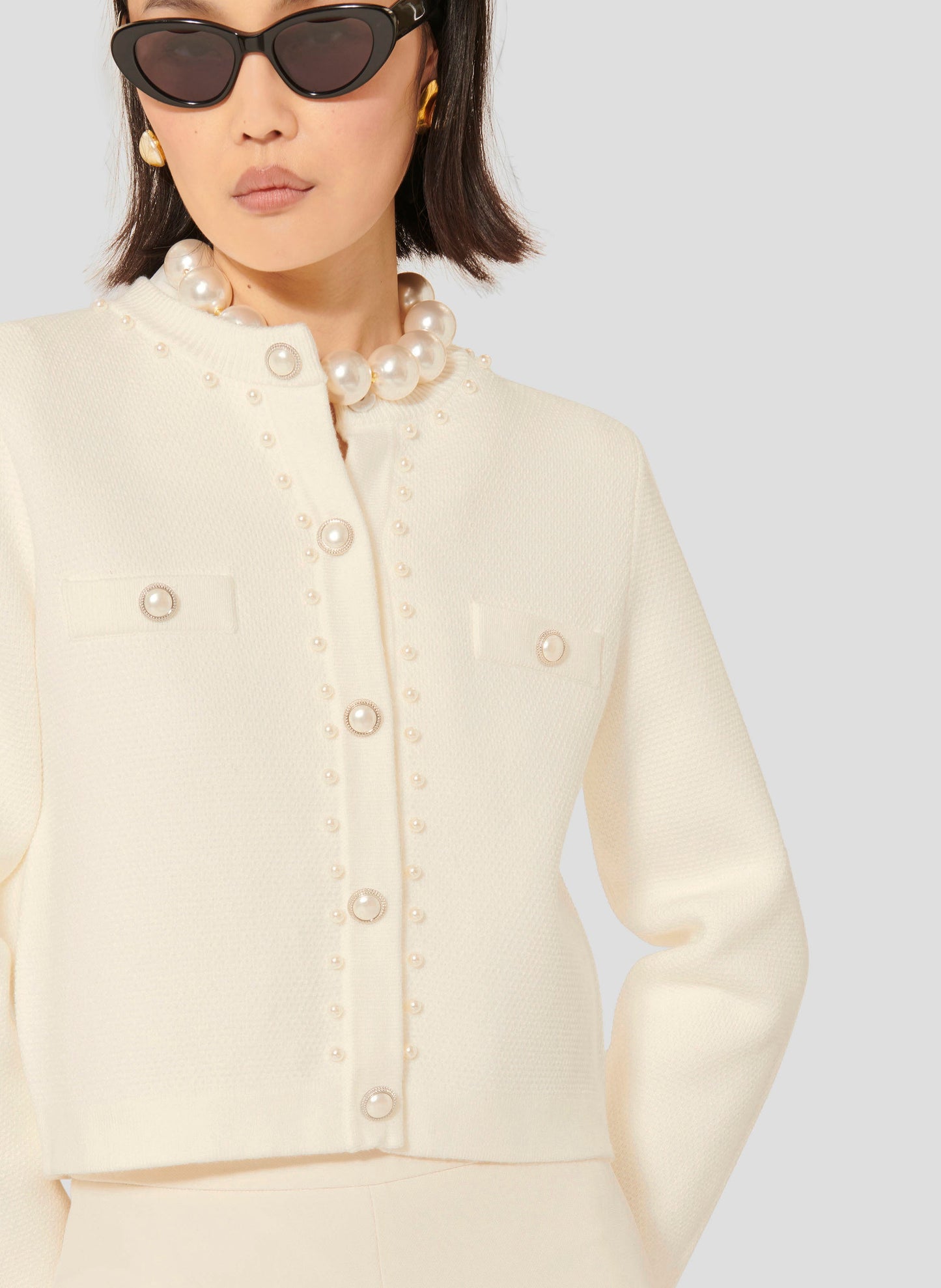 Women's ecru knitted cardigan with pearl buttons. 