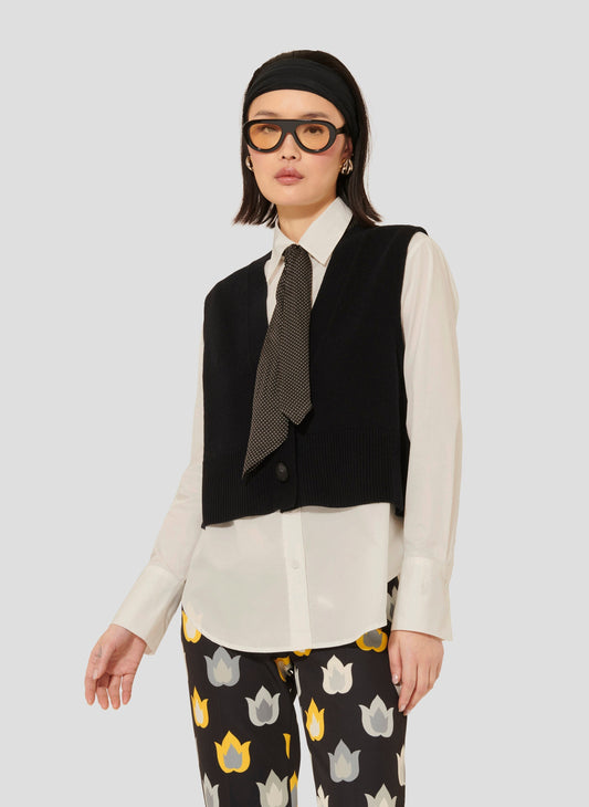 Tara Jarmon model wearing sleeveless black cardigan in merino wool and alpaca.