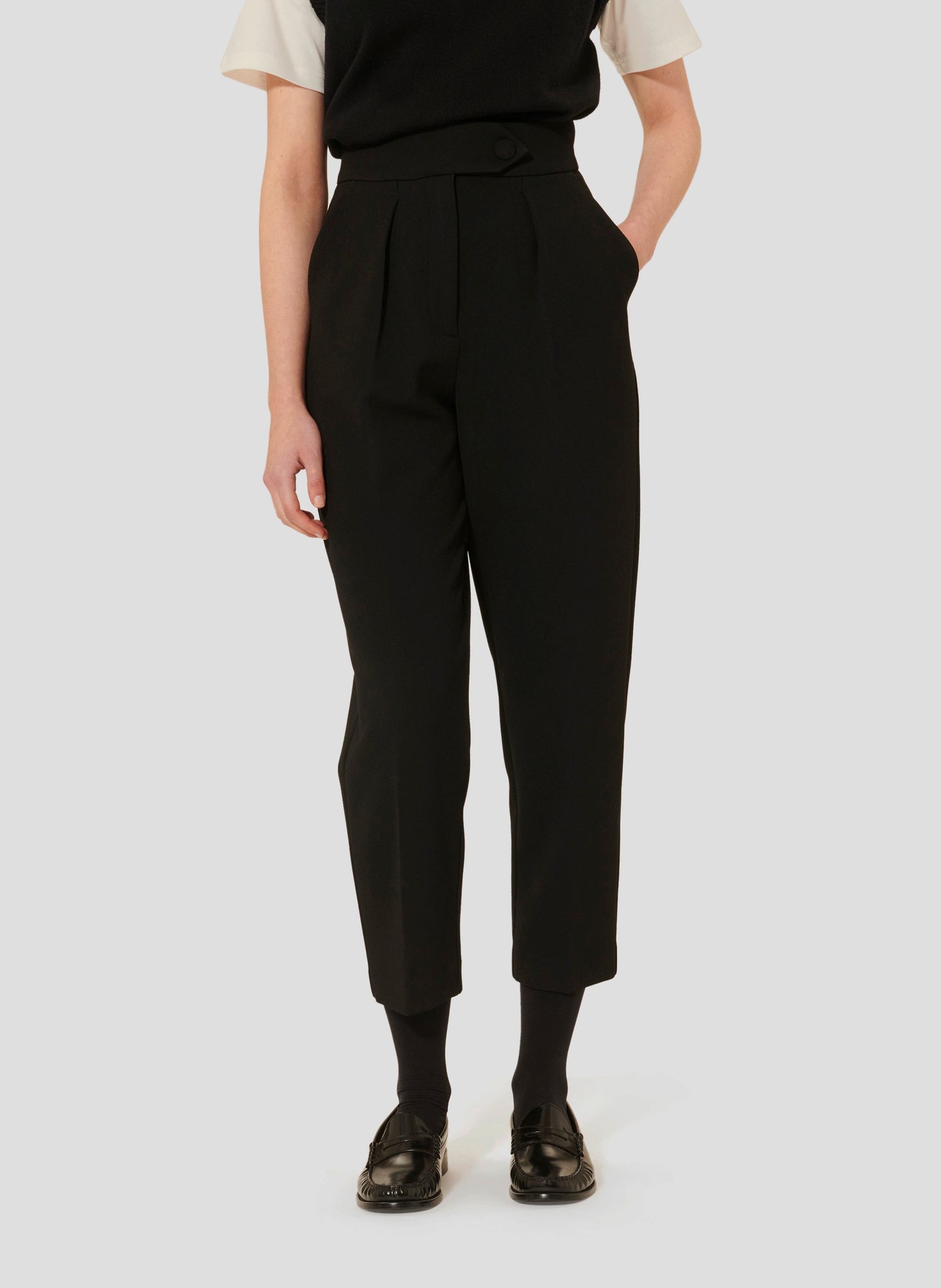 Black crepe straight cut pants, with side pockets. 