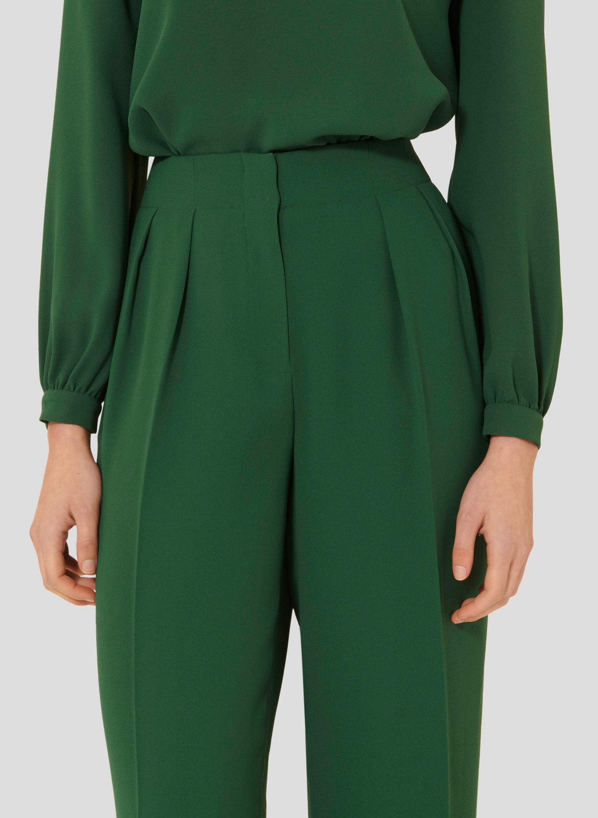 Long cactus green crepe pants with two side pockets. 