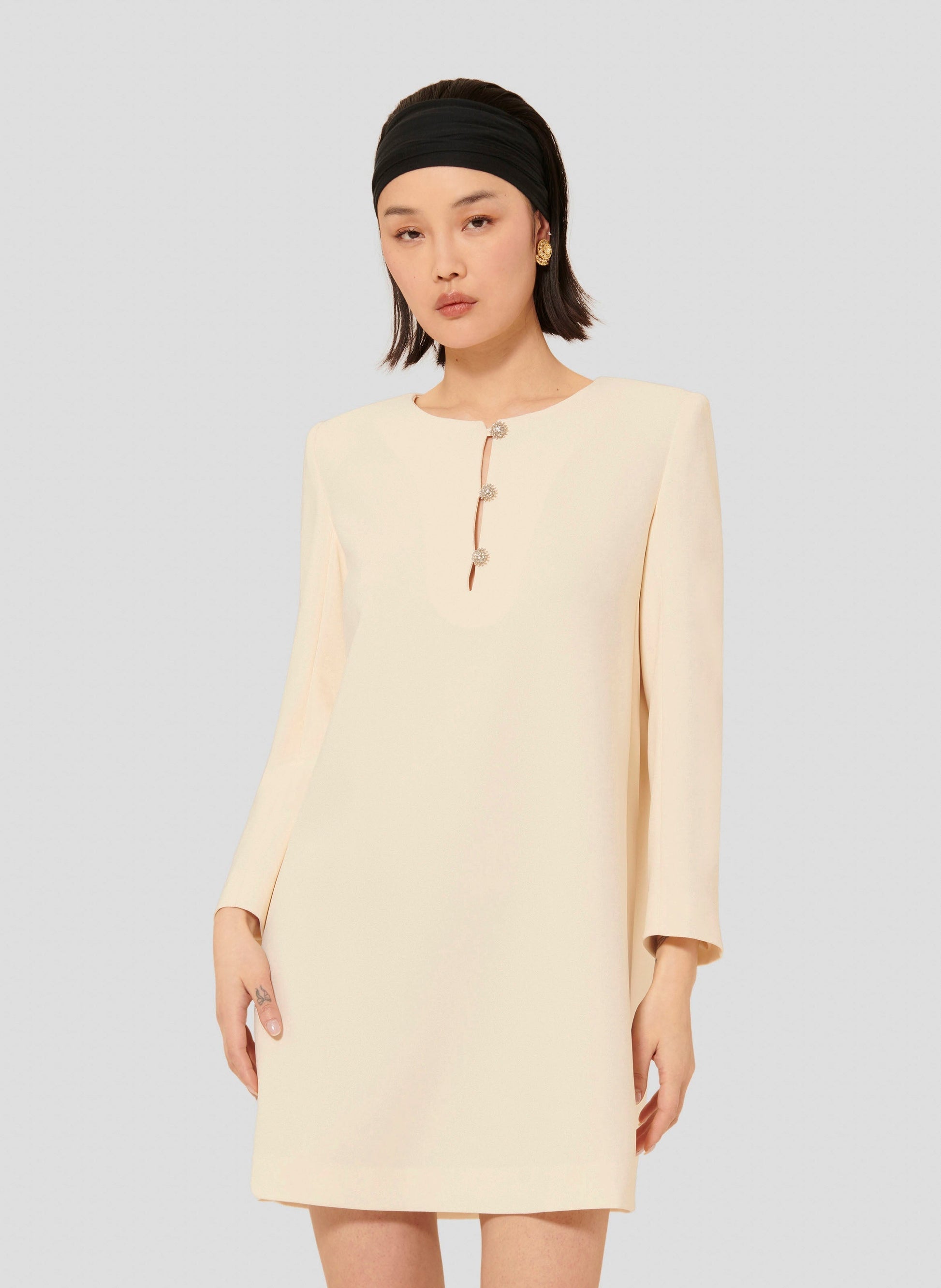 Straight cut short ecru dress with epaulets.
