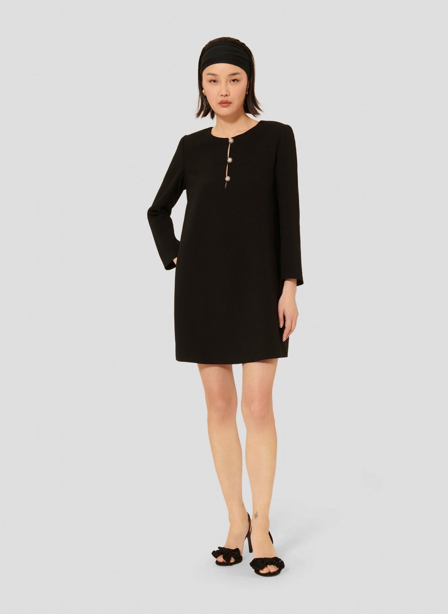 Straight cut short black dress with epaulets.