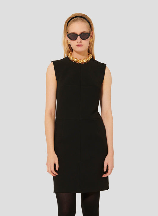 Model wearing Tara Jarmon short black crepe dress. 