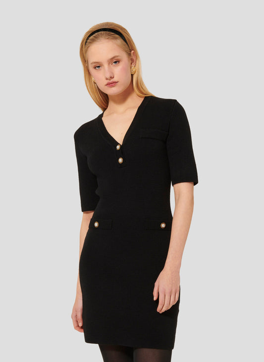 Model wearing Tara Jarmon Black Knit Dress with V-Neck and 3/4-length sleeves.