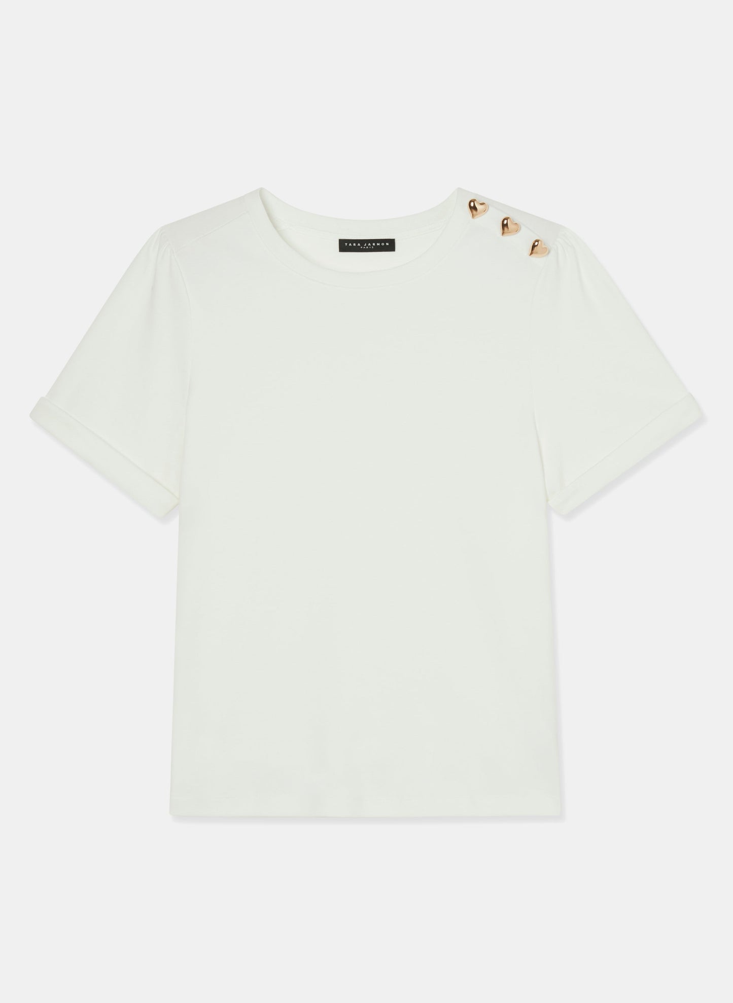 Basic white t-shirt with heart-shaped gold buttons on left shoulder.