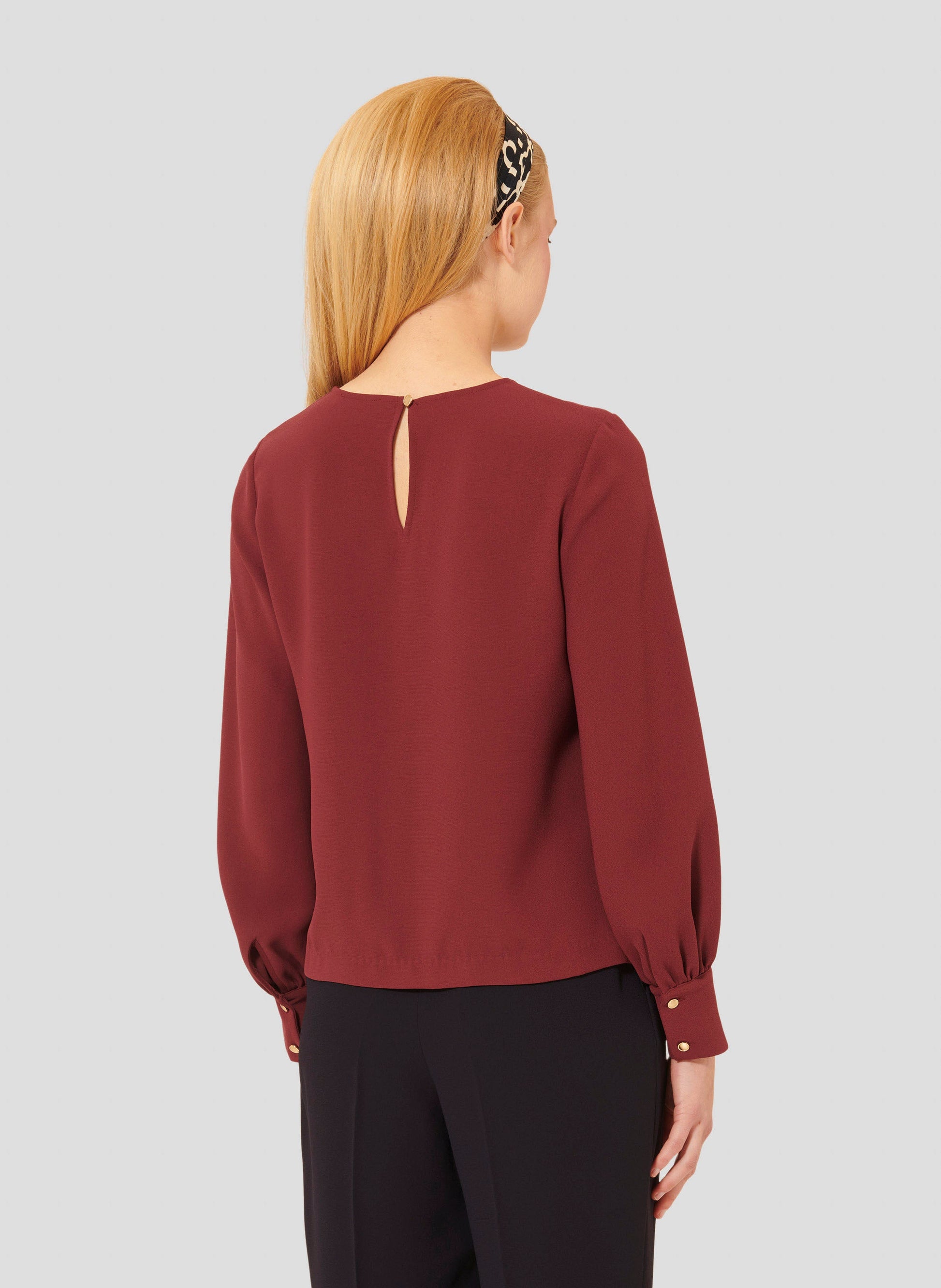 Versatile Burgundy Top with Long Sleeves and Buttoned Cuffs.
