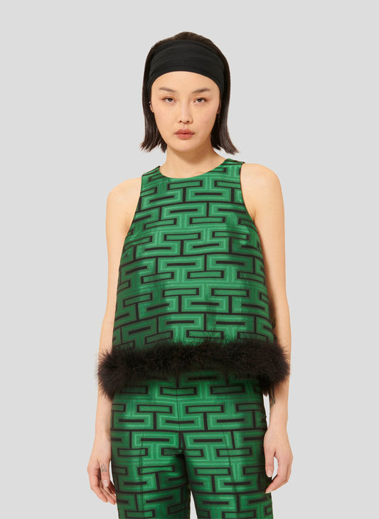 Model wearing Tara Jarmon Sleeveless Top in Emerald Green with Fur Detail.