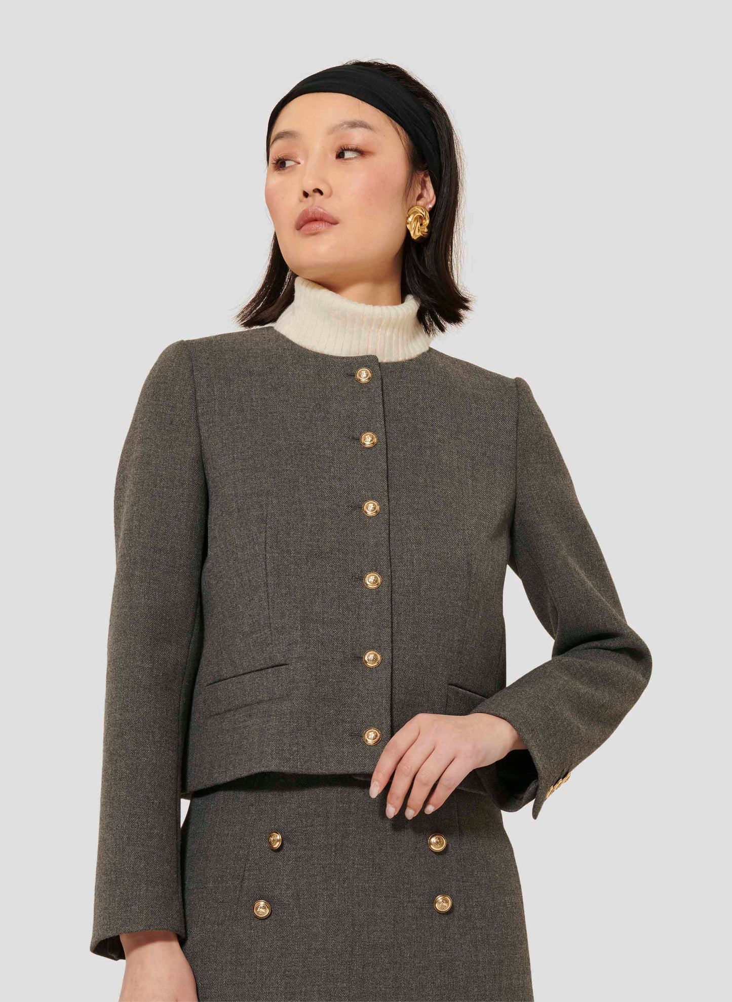 Grey Jacket with Long Sleeves, Round Neckline, and Piped Side Pockets.